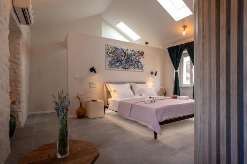 a bedroom with a bed and a painting on the wall at Good vibrations in center 80m2 for 2 GLAVICA in Hvar