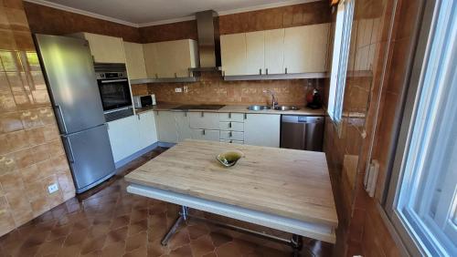 a kitchen with a wooden table with a bowl on it at Casa del Patio in Cangas de Morrazo