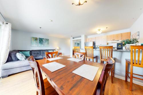 a kitchen and dining room with a wooden table and chairs at Lake Winnipesaukee Retreat in Gilford