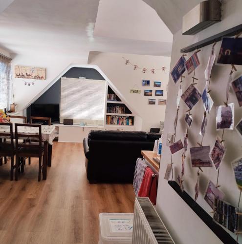 a living room with a couch and a table at Leylands - Perfect location near town and beach in Cromer