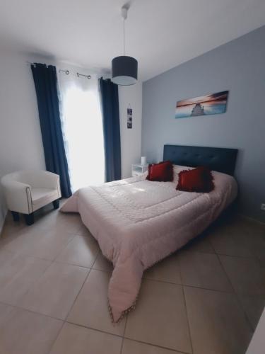 a bedroom with a large bed with red pillows at Charmante demeure au cœur de la provence verte in Bras