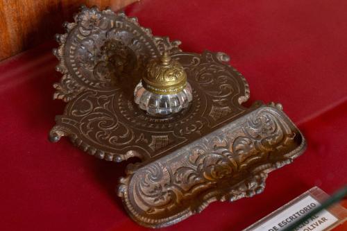 a gold object on a red surface with ascription at Friends Hotel & Rooftop - Historic Center & Museums in Quito