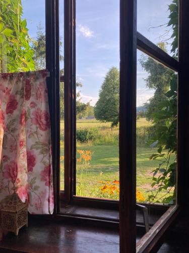 an open window with a view of a field at Stara Szkoła in Krempna
