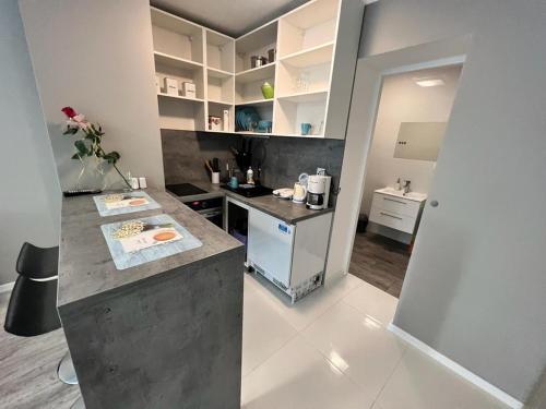 a kitchen with a counter and a counter top at Apartament Portowa K2 in Kołobrzeg