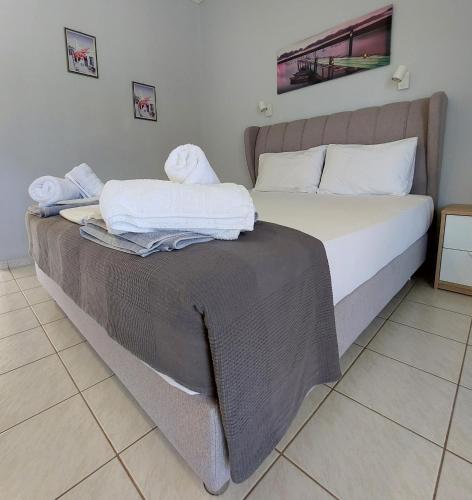 a bedroom with a bed with towels on it at Electra Villa & Pool Studios in Gaios