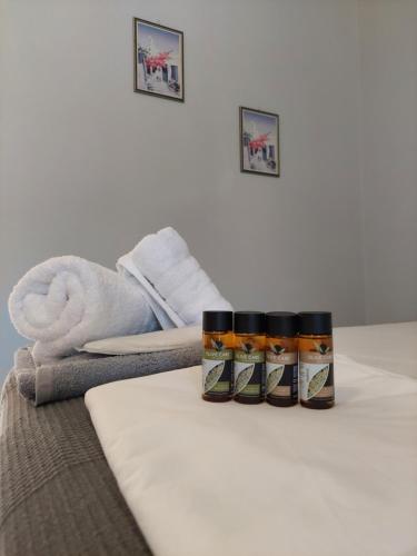 a group of three jars on a bed with towels at Electra Villa & Pool Studios in Gaios