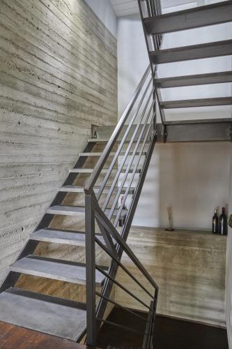 a metal staircase in a room with a wooden wall at Borgo San Gregorio in Sorbo Serpico