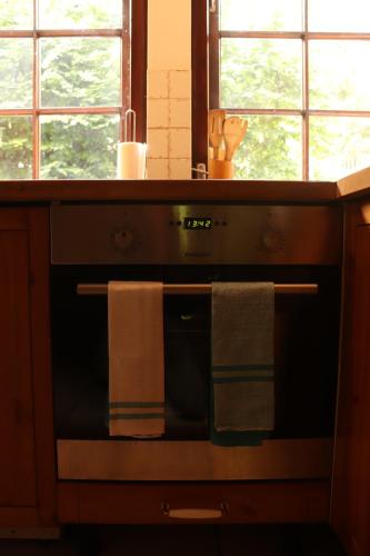 a kitchen with an oven with two towels on it at Birchy Hills in Sitno