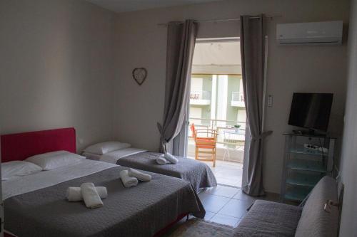 Postel nebo postele na pokoji v ubytování Zoe Apartments