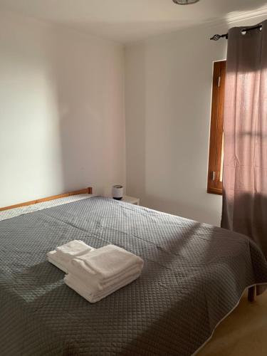 AroeiraにあるAroeira Beach Houseのベッドルーム1室(ベッド1台、白いタオル2枚付)
