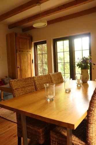 a wooden table with glasses on it in a living room at Birchy Hills in Sitno