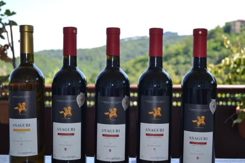 four bottles of wine sitting on a table at Tuta House Sighnaghi in Sighnaghi