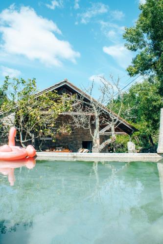 a swimming pool with a house in the background at Just Like Home - Quinta da Cavada em Vilar de Mouros in Caminha