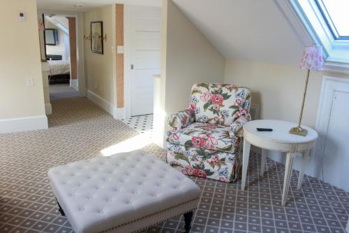 a room with a chair and a stool and a table at Mary's Land Farm in Ellicott City
