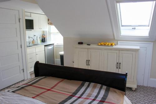 a kitchen with a bed in a room with a window at Mary's Land Farm in Ellicott City