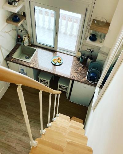 a staircase leading up to a tiny kitchen with a counter at Villa Ulyana Sarti - Ancient Greece in Center in Sarti