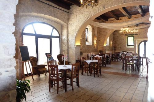 a restaurant with tables and chairs in a building at Antica Taverna del Principe in Sepino