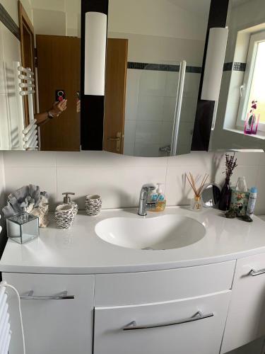 a bathroom with a white sink and a mirror at Haus Sunshine in Novigrad Istria