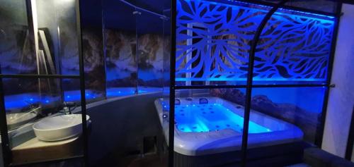 a bathroom with a jacuzzi tub with blue lighting at Nina Apartment in Chania Town