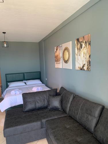 a living room with a couch and a bed at Bledi Hotel in Shëngjin