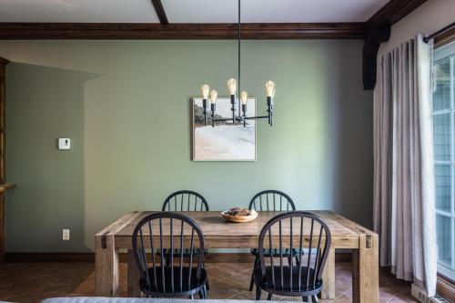 uma sala de jantar com uma mesa de madeira e cadeiras em Le Boisé (Les Manoirs) Mont-Tremblant em Mont-Tremblant