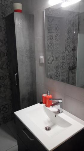 a bathroom with a white sink and a mirror at Alex Seaview House in Chorefto