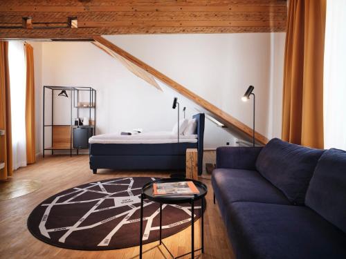a living room with a couch and a bed at LJ5 - Old Town Rooms with Exclusive shared Roof Terrace in Tallinn