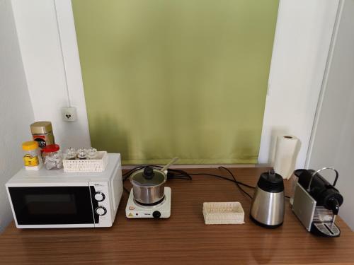 a kitchen with a microwave and a toaster on a table at 1 Zimmer Studio mit Kitchenette in Bad Ragaz