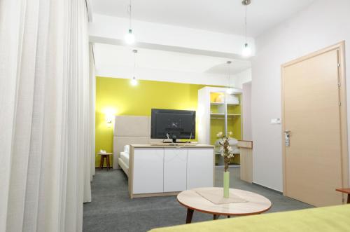 a room with a bed and a tv on a table at Hotel Tim's in Skopje