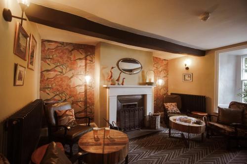 a living room with furniture and a fireplace at Royal Oak Hotel in Rosthwaite