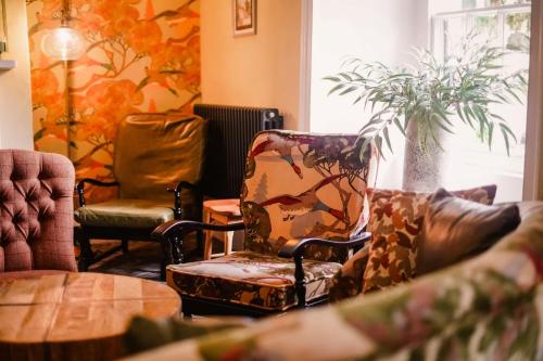a living room with two chairs and a table at Royal Oak Hotel in Rosthwaite