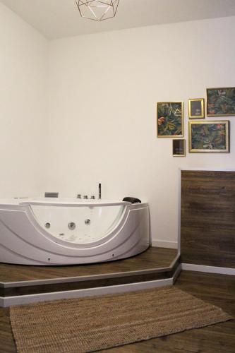 a large white bath tub in a room at La Petite Famille in Corchiano
