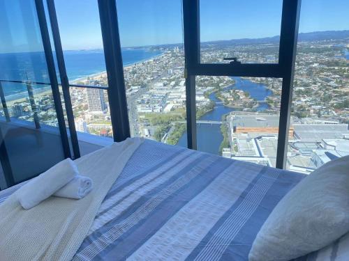 a bed in a room with a view of a city at Skyline at Casino 2bedrooms in Gold Coast