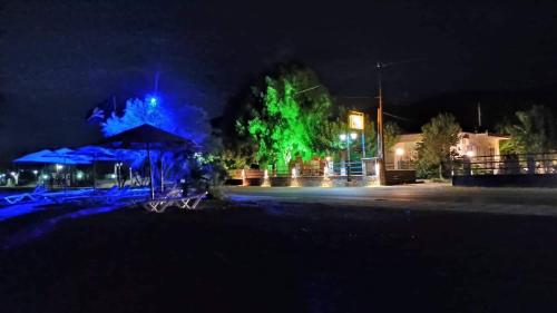a building with blue and green lights at night at Holiday Tolofona Beach in Eratini