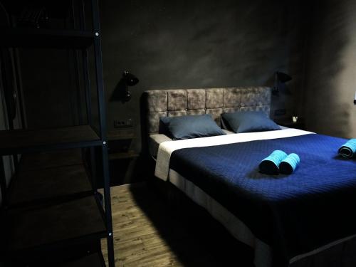 a bedroom with a bed with two slippers on it at House of Silence in Trogir