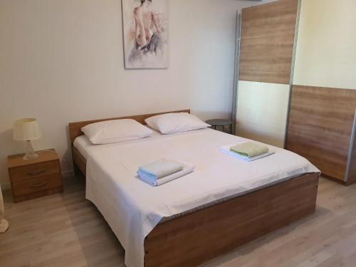 a bedroom with a bed with two towels on it at apartman Luka in Sinj