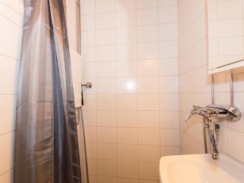 a bathroom with a shower with a toilet and a sink at Santa's Apartment in Rovaniemi