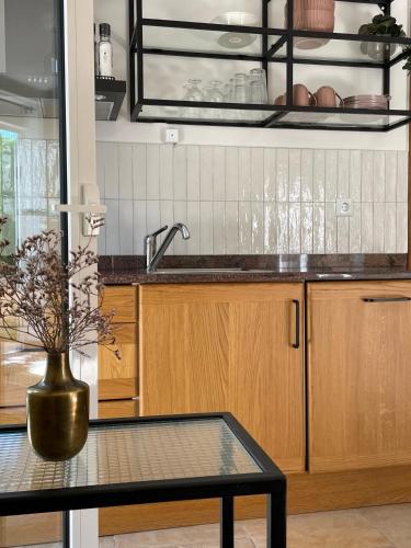 a kitchen with a sink and a vase on a table at Villa Lantana in Vir