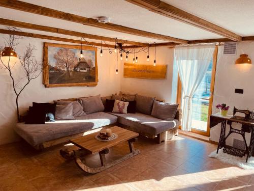 a living room with a couch and a table at Wellness Holiday House Lagev in Moravske Toplice