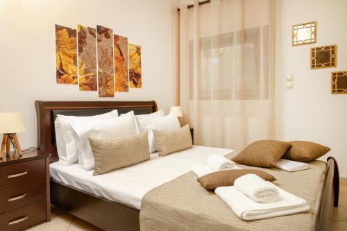 a bedroom with a bed with two towels on it at IFESTOS APARTMENTS in Ierissos