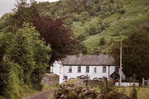 a white house on the side of a road at Royal Oak Hotel in Rosthwaite
