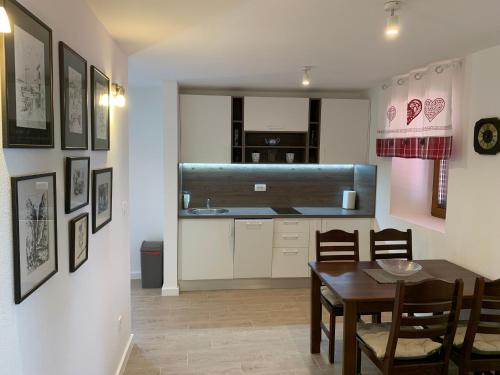 a kitchen and dining room with a table and a dining room at Apartment Centar in Buljarica