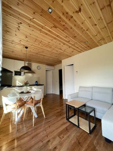 a living room with a table and a couch at El BURGO DE OSMA ALOJAMIENTO RURAL VILLA BAGH in El Burgo de Osma