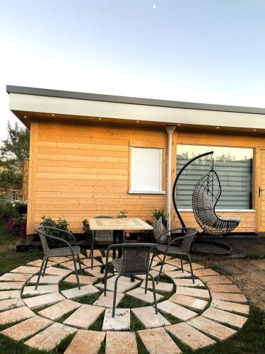 a patio with a table and chairs in front of a house at El BURGO DE OSMA ALOJAMIENTO RURAL VILLA BAGH in El Burgo de Osma