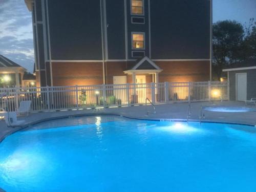 a large blue swimming pool in front of a building at The ShoreHouse in Ocean City