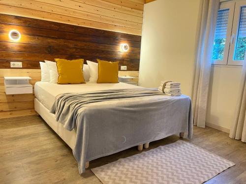 a bedroom with a large bed with yellow pillows at El BURGO DE OSMA ALOJAMIENTO RURAL VILLA BAGH in El Burgo de Osma