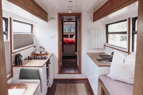 uma pequena cozinha com um fogão e um lavatório em Relaxing retreat for 2 on beautiful converted bus em Levaré
