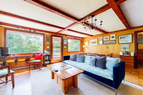 a living room with a blue couch and a table at Notch Lodge in Franconia