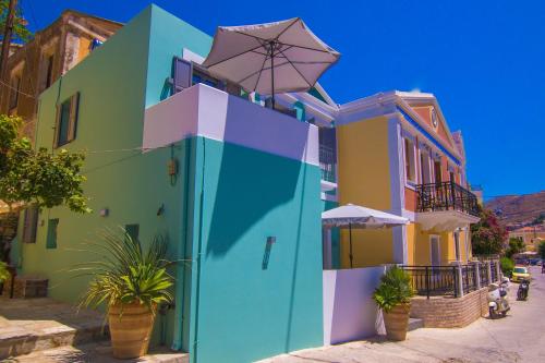 a colorful building with an umbrella on top of it at Ialemos Group in Symi