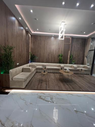 ein Wohnzimmer mit einem Sofa und einem Tisch in der Unterkunft الاتحاد الذهبية للشقق المخدومة 2 in Al-Hasa